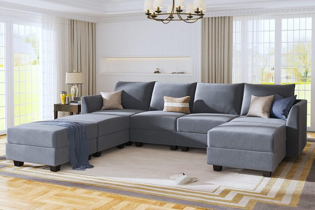 A modern modular sectional sofa in a spacious living room, featuring a sleek design and plush cushions for maximum comfort.