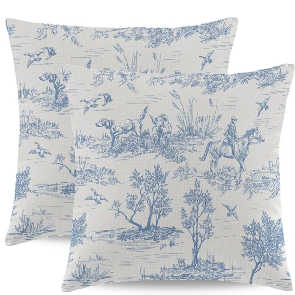 Blue and white decorative throw pillows on a neutral sofa in a cozy living room